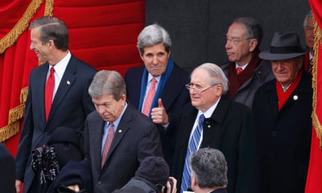 Senator John Kerry gives a thumbs-up gesture as he arrives at the Capitol building.