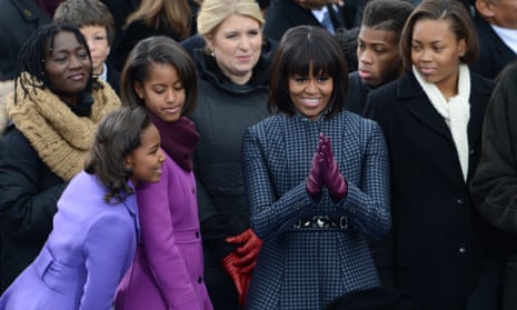 Sasha,Malia and Michelle Obama arrive for ceremonies. For those interested in the fashion: Michelle is wearing a Thom Browne coat and dress. Malia is wearing a J Crew ensemble. Sasha is wearing a Kate Spade coat and dress.