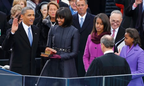 Supreme Court Chief Justice John Roberts administers the oath of office to President Barack Obama as first lady Michelle Obama holds the bible and daughters Malia and Sasha look on.