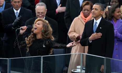 Beyonce performs the national anthem as Barack Obama looks on.