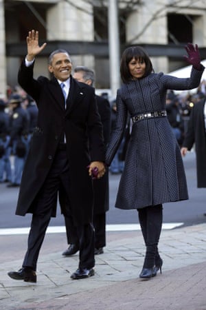 Barack and Michelle Obama wave as they walk down Pennsylvania Avenue during the inauguration parade.