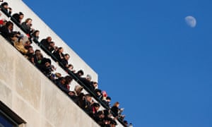 Spectators watch Barack Obama go by during the inaugural parade.