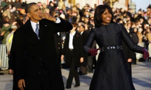 President Barack Obama blows a kiss as he and first lady Michelle Obama walk on Pennsylvania Avenue.