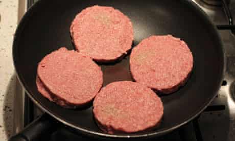 beef burgers in frying pan