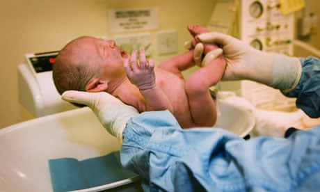 A baby is weighed after being born in an NHS maternity unit