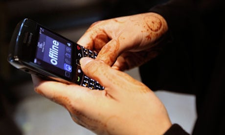 A woman uses her BlackBerry phone