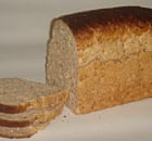Loaf of brown bread, some of it sliced