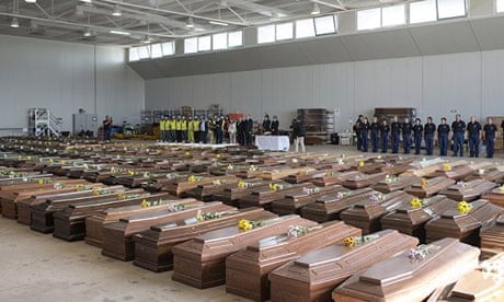 EU delegates pay tribute before rows of coffins containing the bodies of Lampedusa shipwreck victims