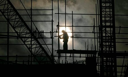 A labourer works on scaffolding at a construction site in Wuhan