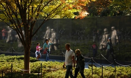 Visitors walk through the Korean War Veterans Memorial after it was reopened to the public in Washington.