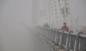 Smog is the problem for people crossing a bridge in Jilin, Jilin province, China.