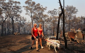 Melissa White and her sister Christie Daschke and dogs at her home that was destroyed by bushfire on in Winmalee, Australia.