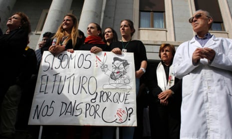 Spanish scientists during the minute's silence in Madrid on 17 October. The banner reads: "If we are the future why are our asses being kicked?"