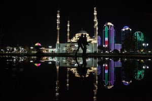 People walk in downtown Grozny, capital of Chechnya, as the Central Mosque is reflected in the water. The capital of Chechnya, rebuilt after two devastating separatist wars in the 1990s, boasts the largest mosque in Europe.
