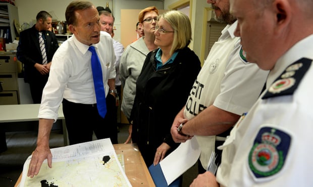Part of Australian life: Tony Abbott and the federal MP for Macquarie, Louise Markus, are briefed by Rural Fire Service incident controller David Jones (second right) and RFS commissioner Shane Fitzsimmons.
