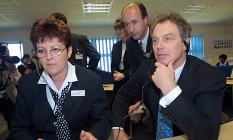 Tony Blair listens to calls at an NHS Direct call centre