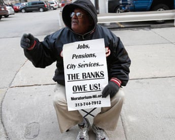 A pensioner protests pensions cuts in Detroit