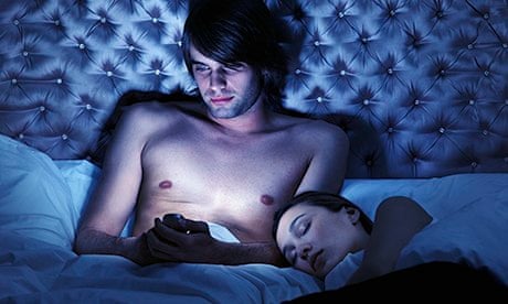 Man on mobile in bed