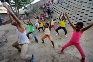 Alexandra Township: Dance instructor shows school children dance moves