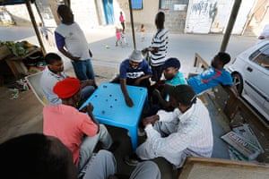 Alexandra Township: Men play a communal board game