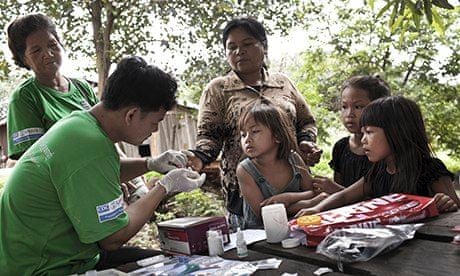 A village health worker tests a woman for malaria in Pailin as part of Malaria Consortium’s Malaria 