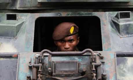 A member of Honduras' military police sits in a tank during a presentation in Mateo. The new military police unit consisting of 5,000 personnel who will be in charge of police operations, public order and safety.
