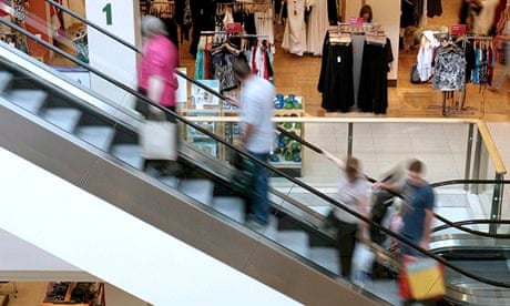 Customers travel up escalators