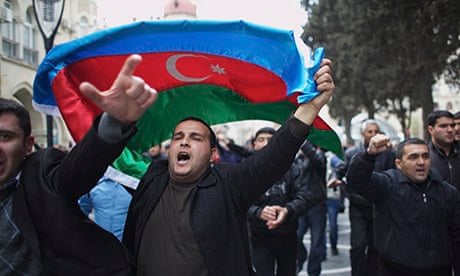 Protesters wave national flags as they rally in Baku, Azerbaijan ahead of the national elections
