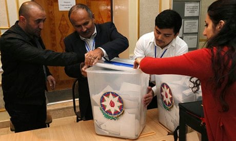 Members of Azerbaijan's electoral commission prepare to count ballots at a polling station in Baku