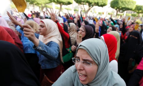 Cairo University students and members of the Muslim Brotherhood shout protest against the military.