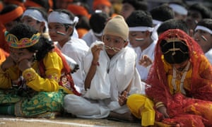 A child dressed as Mahatma Gandhi sits with fellow students as they take part in state formation day celebrations in Hyderabad .