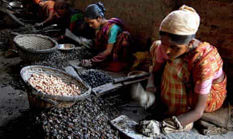 Indian women work at a cashew factory in Agartala