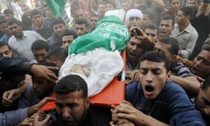 Palestinians carry the body of the local commander of Hamas's military, Rabieh Barikeh