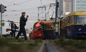 Police officers investigate at the crash site of two trams in the Bosnian capital of Sarajevo. Authorities say around 45 people were injured when one tram slammed into another at a busy downtown intersection.