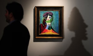'Tete de femme' by Pablo Picasso is on display next to a shadow of Alberto Giacometti's sculpture 'Grande tete de Diego', is projected on a wall during a press preview of Sotheby's auction of impressionist and modern art, at Sotheby's in New York. The auction is scheduled to take place on November 6.