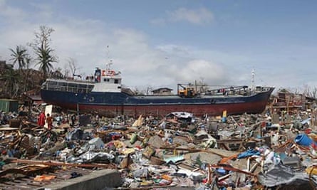 A boat washed ashore sits on destroyed houses in Tacloban.