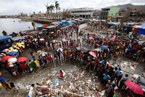 Victims queue for food and water in the aftermath of super typhoon Haiyan in Tacloban city.