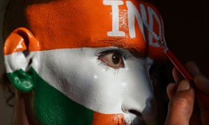 A fan of Indian cricketer Sachin Tendulkar, paints his face with the colours of the Indian national flag ahead of a cricket match.