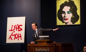 Dan Colen's artwork titled, "Holy Shit" and Andy Warhol's artwork titled "Liz #1 (Early Colored Liz)" are auctioned at Sotheby's in New York City.