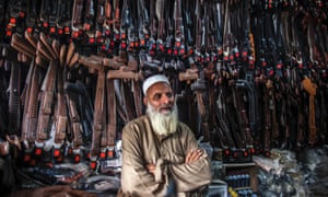 A vendor is photographed in his shop specialising in gun holsters in the city of Mardan in Pakistan.