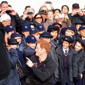 Prince Harry proves popular with the children from Corpus Christi Roman Catholic Primary School Brixton in London today.