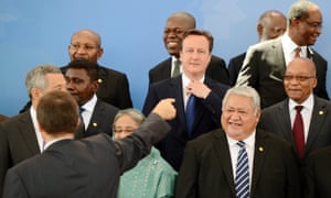 Here David Cameron adjusts the knot of his tie as he and other Heads of State belonging to the Commonwealth find their places for a group portrait photograph at the CHOGM summit in Colombo. Cameron then travelled to the north of the country.