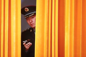 A member of the People's Liberation Army (PLA) is seen behind a curtain before a welcoming ceremony for Dutch Prime Minister Mark Rutte with his Chinese counterpart Li Keqiang (both not pictured) at the Great Hall of the People in Beijing.