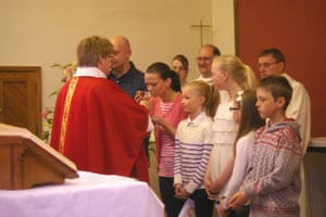 Church congregations: vicar giving communion