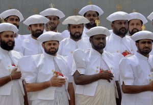 Sri Lankan men in traditional costume pose for a photograph before the first working session of the Commonwealth Heads of Government Meeting (CHOGM) at the Bandaranaike Memorial International Conference Hall (BMICH) in Colombo.  Britain's Prince Charles formally opened a Commonwealth summit in Colombo whose build-up has been dogged by a dispute over rights abuses at the end of Sri Lanka's ethnic war.