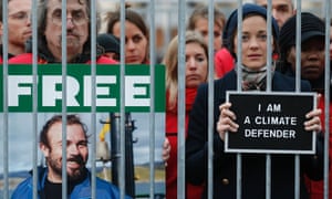 French actor Marion Cotillard (right) and Greenpeace activists protest inside a mock prison cell, in support of the Arctic 30, during a protest at Palais-Royal in Paris.