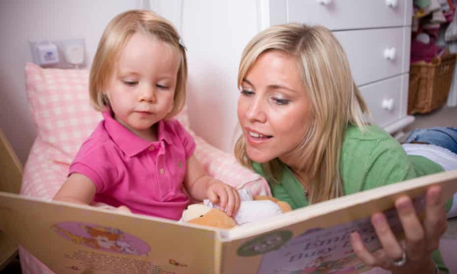 A mother reads to her daughter.