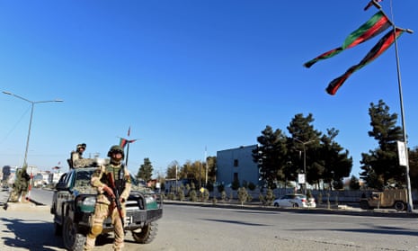 Afghan policeman look on in Kabul.