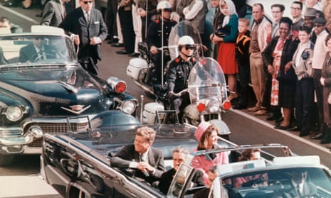 JFK and Jackie Kennedy smile at the crowds lining their motorcade route in Dallas, Texas, on November 22, 1963.