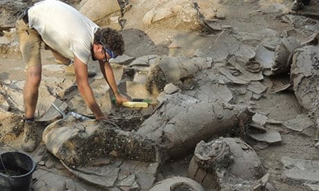 Archaeologist Zach Dunseth removes debris from ancient wine jars excavated in Israel